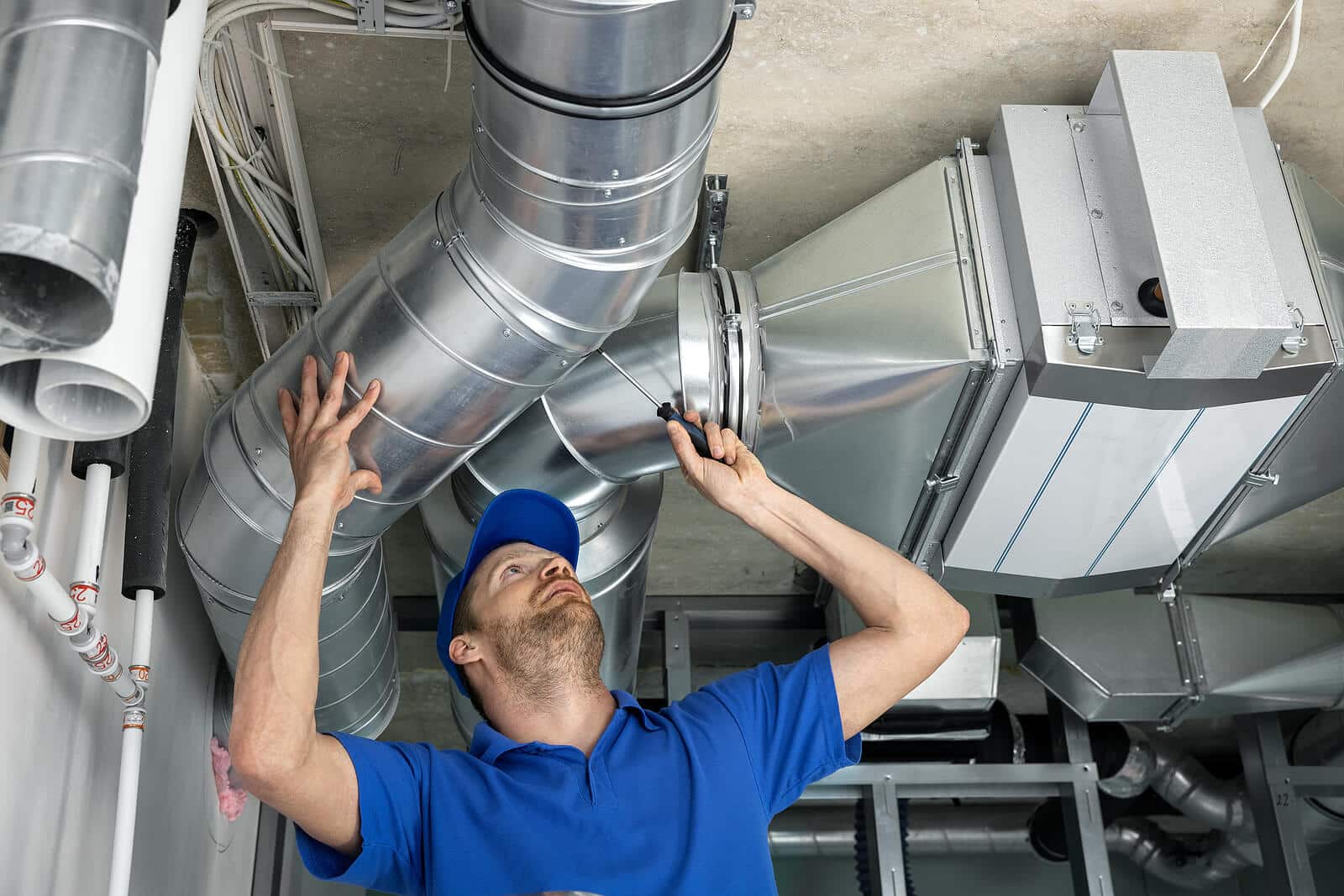 HVAC technician inspecting and repairing air ducts in Santa Maria