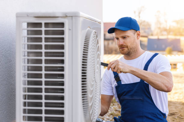 HVAC technician servicing an outdoor air conditioner in Santa Maria